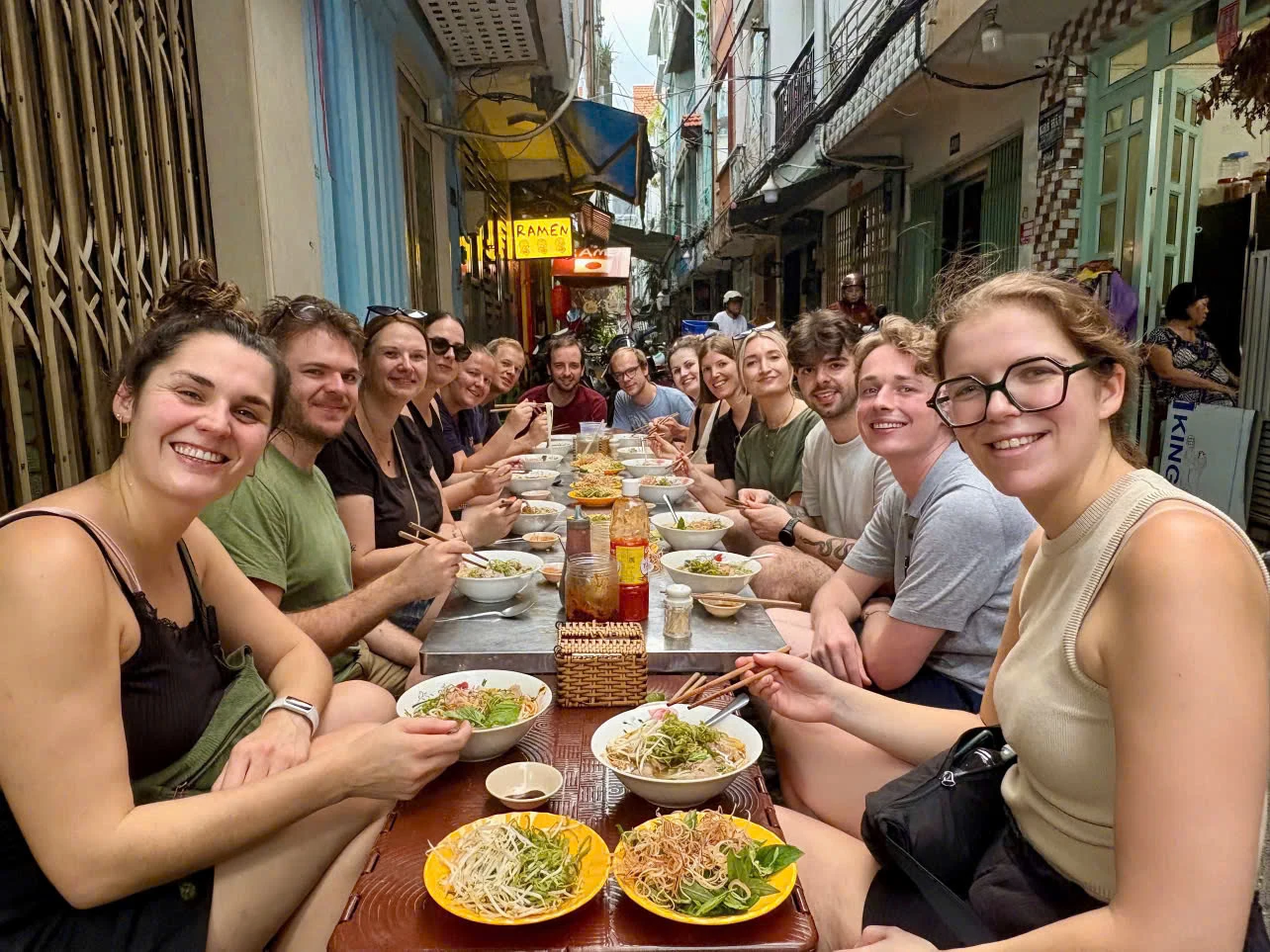 Travelers eating local food together