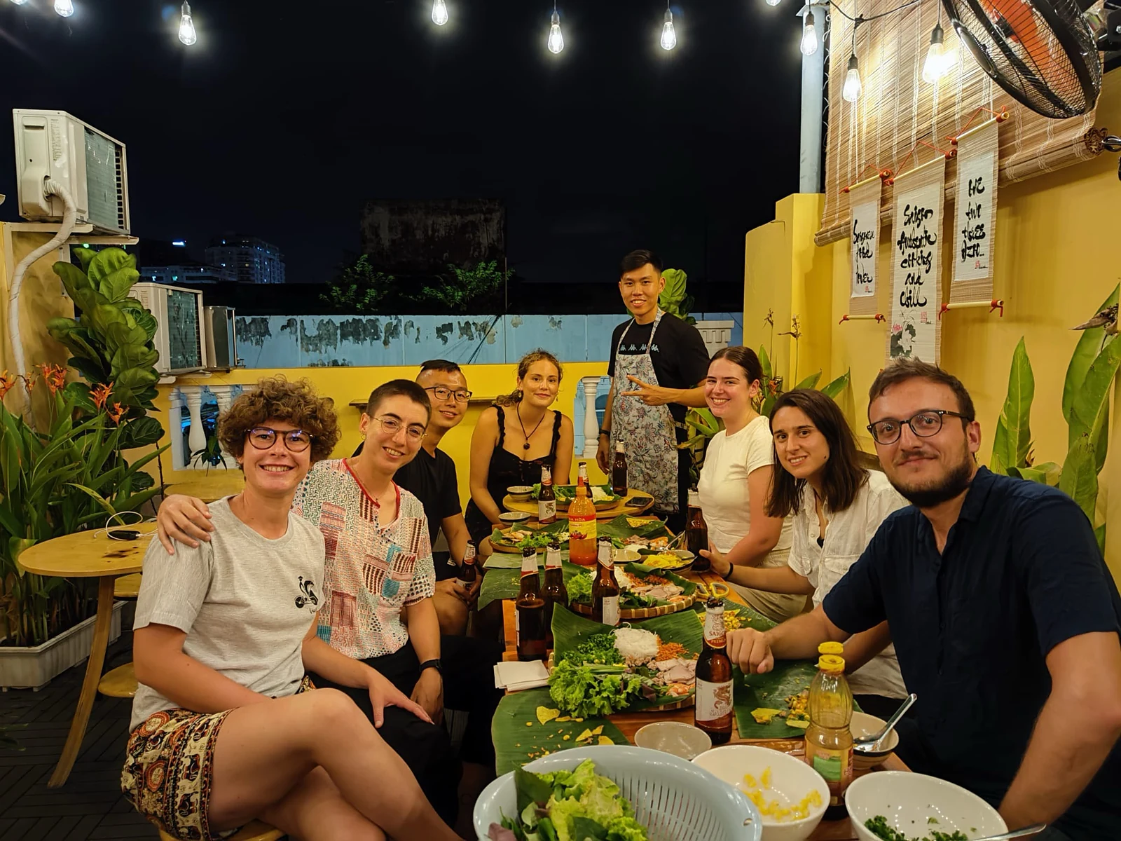 Travelers sharing dinner on the rooftop